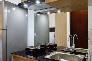 Fridge, stovetop, cookware/dishes/utensils - Serene Exclusive Modern Studio Apartment At Grand Sungkono Lagoon (Surabaya)