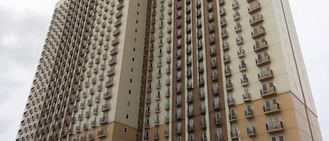 A high-rise residential building with multiple balconies and a sign reading "Aralea" at the base.