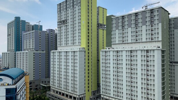 A high-rise residential building with multiple floors, large windows, and a modern architectural design. - Comfort And Minimalist 2Br At Maple Park Sunter Apartment (Jakarta)