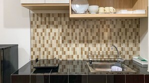 Fridge, stovetop, cookware/dishes/utensils - Comfort Studio Room At Margonda Residence 5 Apartment (Depok)