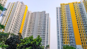 A high-rise residential building with multiple balconies and a yellow accent on the facade. - Well Designed 2Br Apartment At Springlake Summarecon Bekasi (Bekasi)