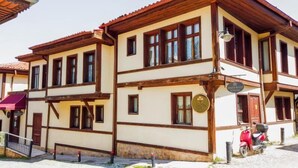 A traditional building with a two-story structure, wooden beams, and a red-tiled roof. - Arasta Konak Otel (Eskisehir)