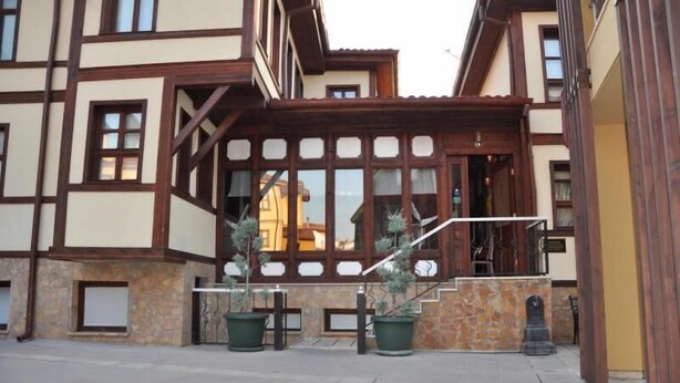 A traditional building with a stone base, wooden upper structure, and large windows. - Arasta Konak Otel (Eskisehir)