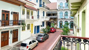 A narrow street with buildings on either side, featuring balconies, doors, and windows. - Apartment in the Heart of Casco Viejo Panama 11 (Panamá)