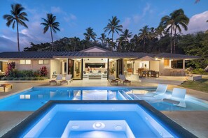 A modern house with a swimming pool, outdoor seating, and palm trees. - Expansive Mauna Kea Resort Home, 3 private bdrms and massive kids suite! (Kamuela)