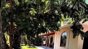 Una hamaca, un patio y un edificio con un área techada.