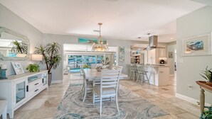 A spacious kitchen with a large island, modern appliances, and a view of the backyard.