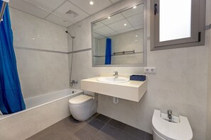 Bathtub, hair dryer, bidet, towels