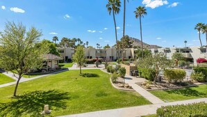 A hotel courtyard with palm trees, a gazebo, and a mountain in the background. - Camelback 446 | Walk 2 Old Town | 4 Pools (Scottsdale)