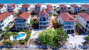 A coastal hotel with multiple buildings, a swimming pool, and a view of the ocean. - Blue Heron - Dog Friendly, Community Pool, Across from Beach, Sunset Beach! (St. George Island)