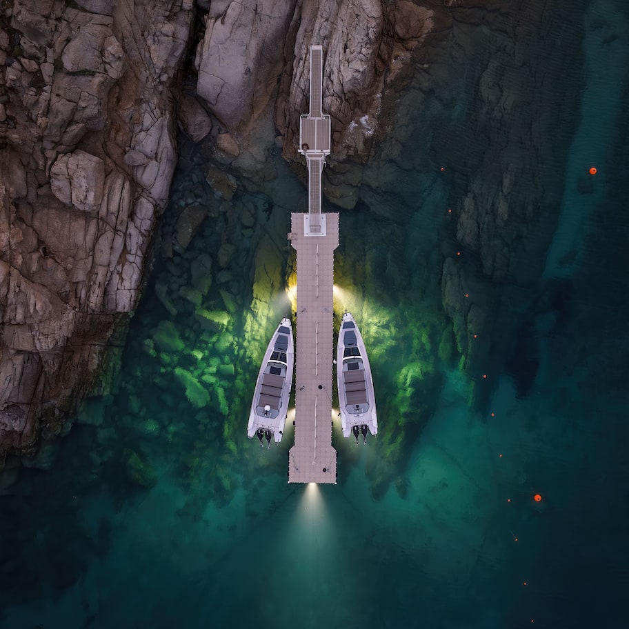A space station docked at a spaceport with multiple docking bays and a clear view of the surrounding rocky terrain.