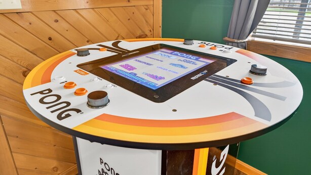 A pong table with a digital screen, buttons, and a nameplate. - Lazy Lane Cabins - Brookside Cabin (South Bloomingville)