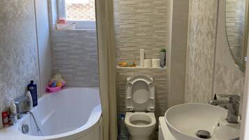 Bathtub, hair dryer, towels, soap