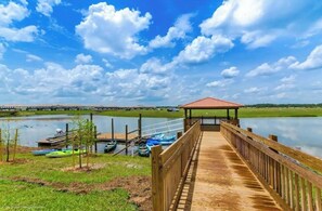 Stroll along the boardwalk to a serene gazebo overlooking a peaceful lake.
