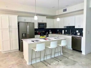 Enjoy cooking in this well-equipped kitchen with a central island and bar stools.