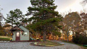 A small cabin with a gravel driveway and a wooden deck. - The 'Happy Go Fishing Cabin' at the Park Place (on Parks Rd)  (Woodleaf)