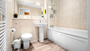 Une salle de bain moderne équipée de toilettes, d’un lavabo et d’une baignoire.