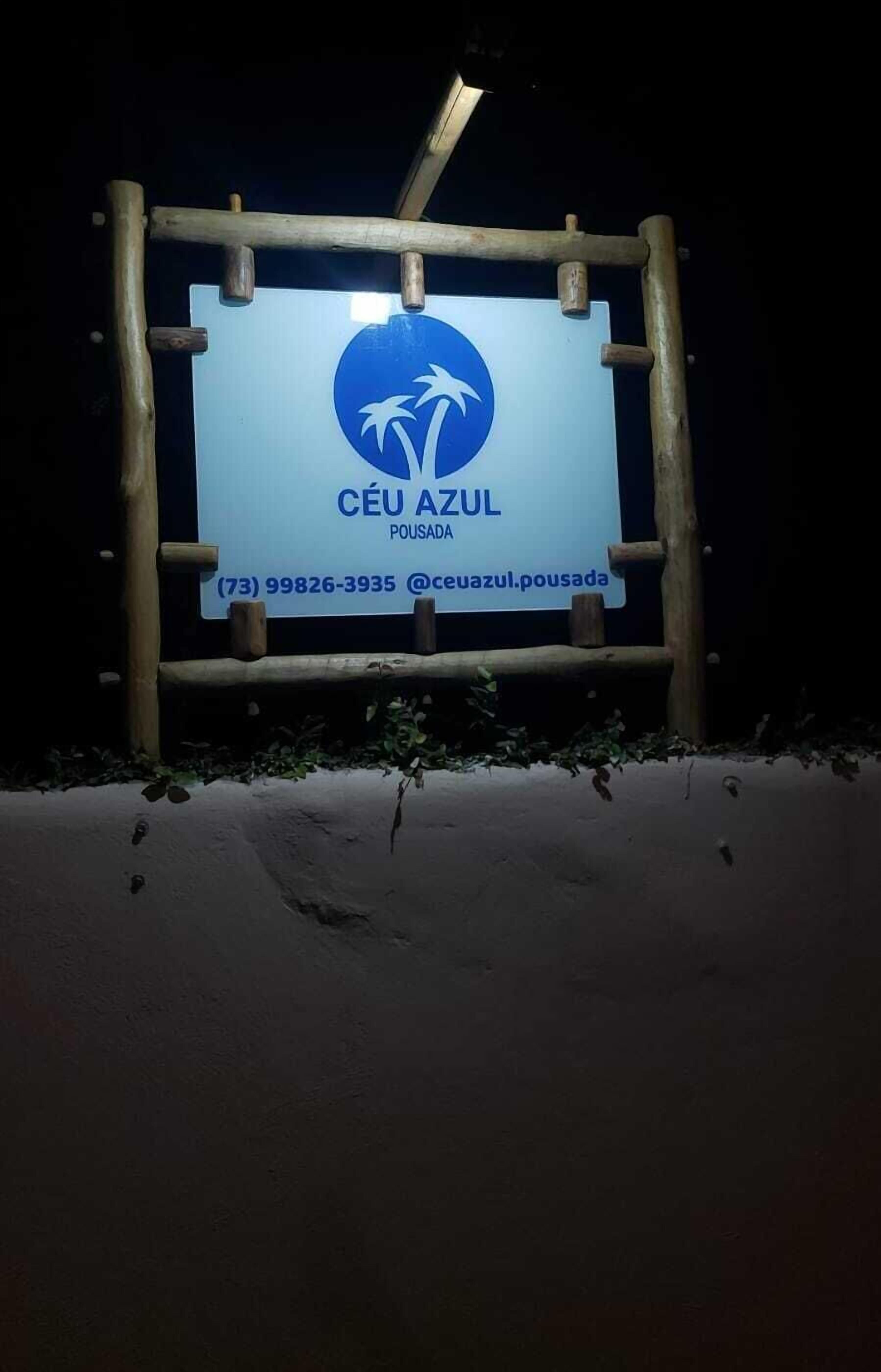 A signboard with the name 'Céu Azul' and contact information.
