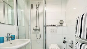 A modern bathroom with a glass-enclosed shower, a white sink, and a toilet. - North Sea Residence App 23 Westerland (Westerland)