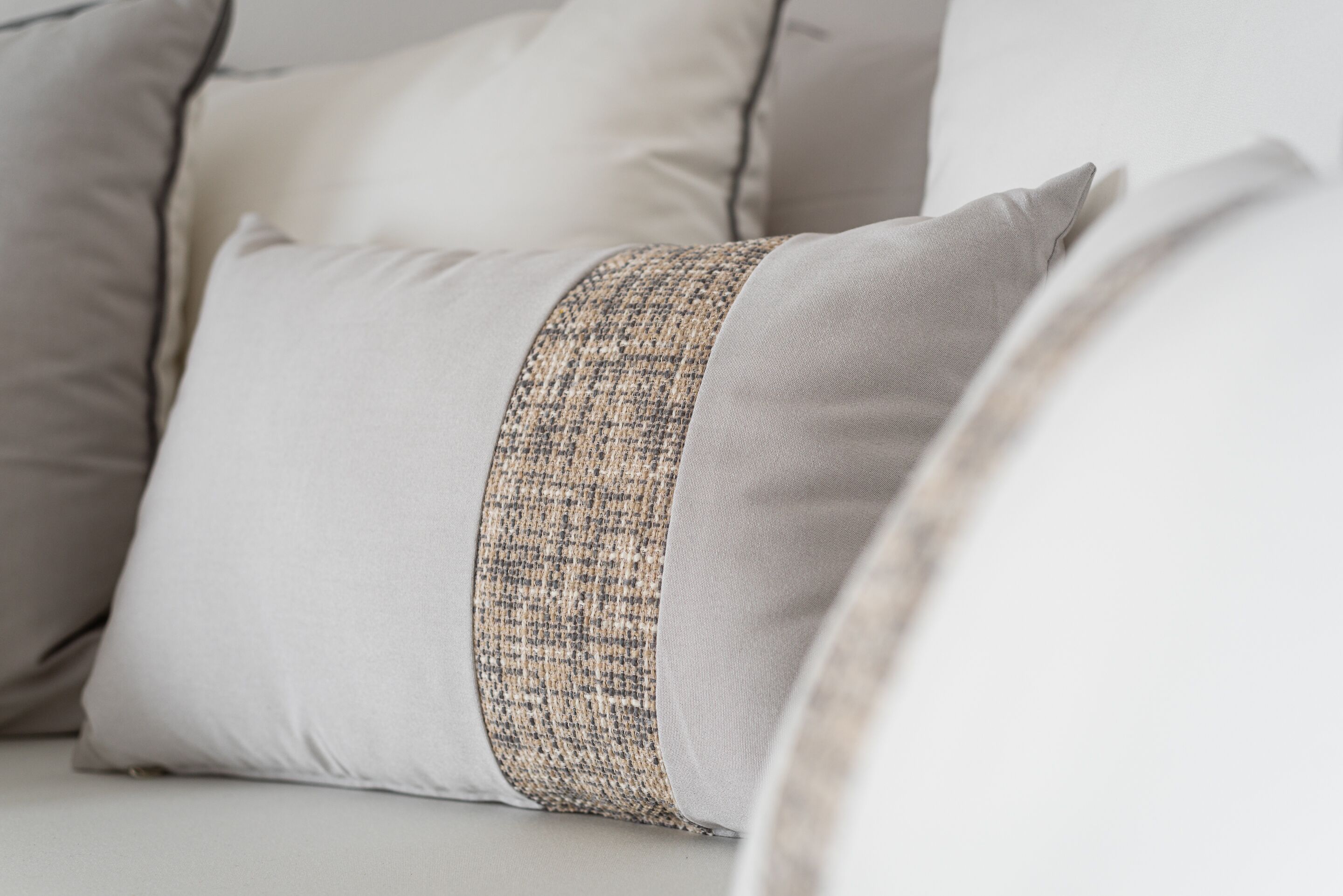 A close-up of a pillow with a textured band.