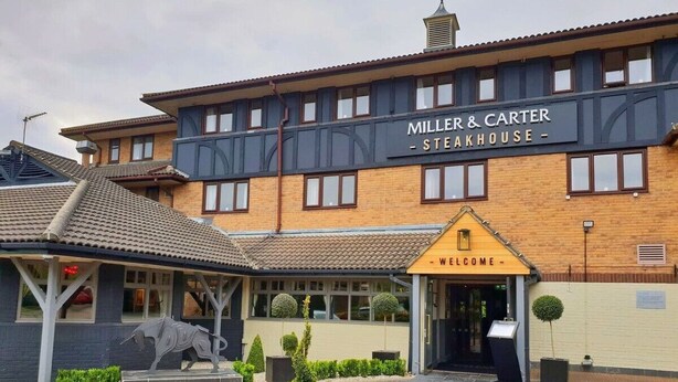 A steakhouse with a sign reading "Miller & Carter Steakhouse" and a "Welcome" sign at the entrance.