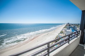 Enjoy breathtaking views of the ocean from this hotel's balcony overlooking a sandy beach.