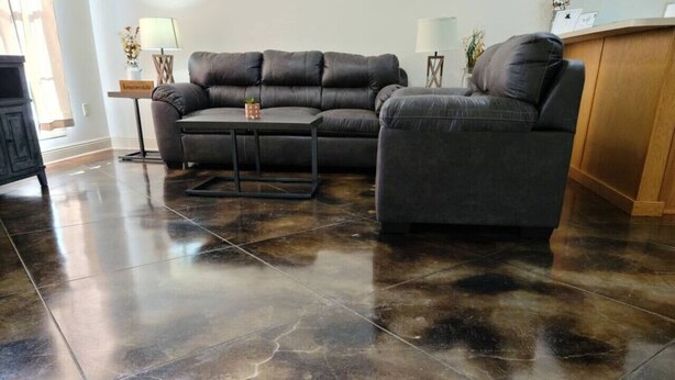 A living room with a dark brown leather sofa, a coffee table, and a polished tile floor. - Chateau 8, spacious townhouse in Tickfaw, LA (Tickfaw)