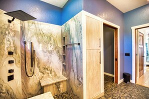 A bathroom with a marble shower enclosure, a wooden bench, and a tiled floor. - Spacious 3 Br Home w/ Pool- 1 mile walk to beach (Nokomis)