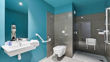 A modern bathroom with a white sink, toilet, and shower.