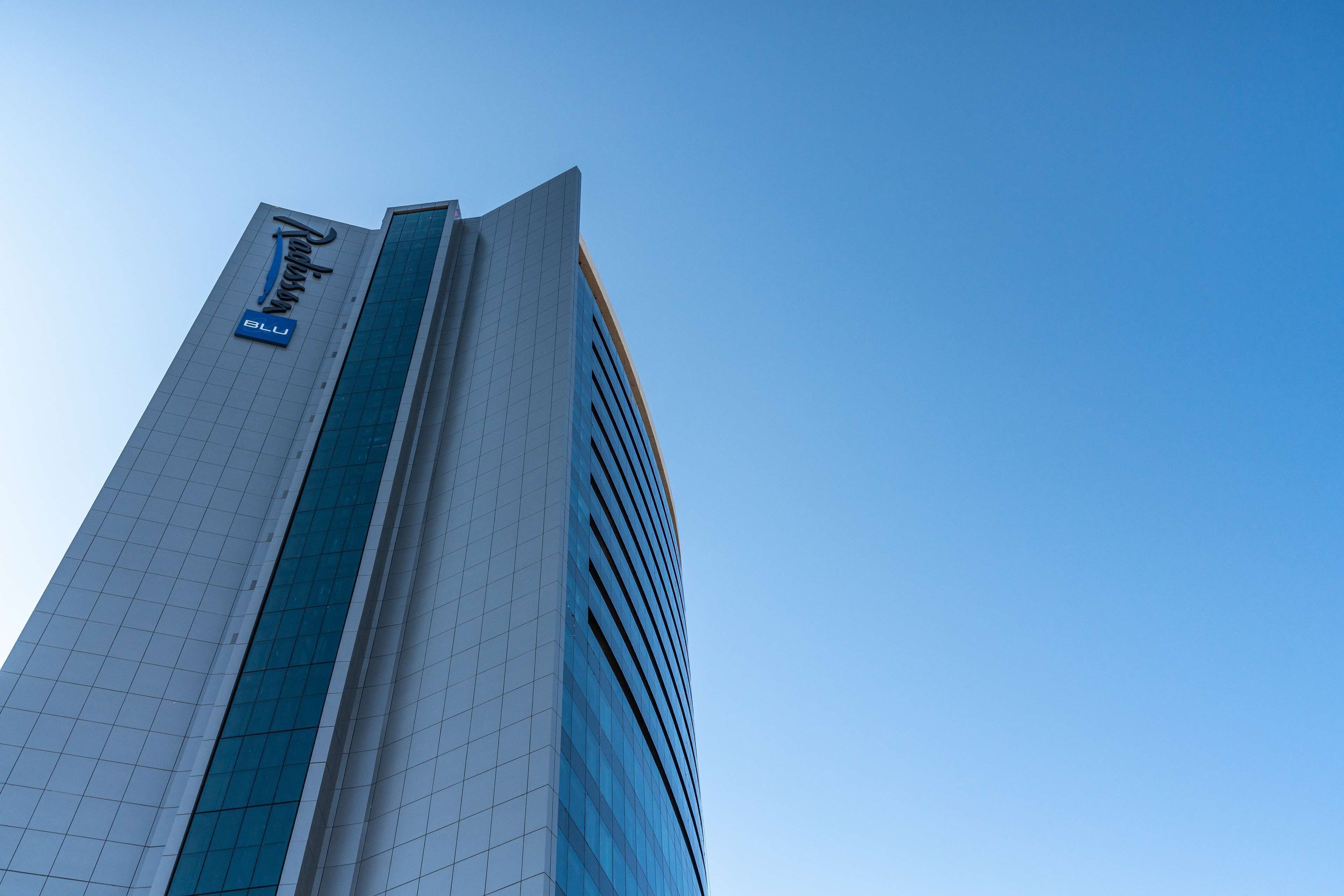 A tall building with a prominent sign reading "Radisson Blu".
