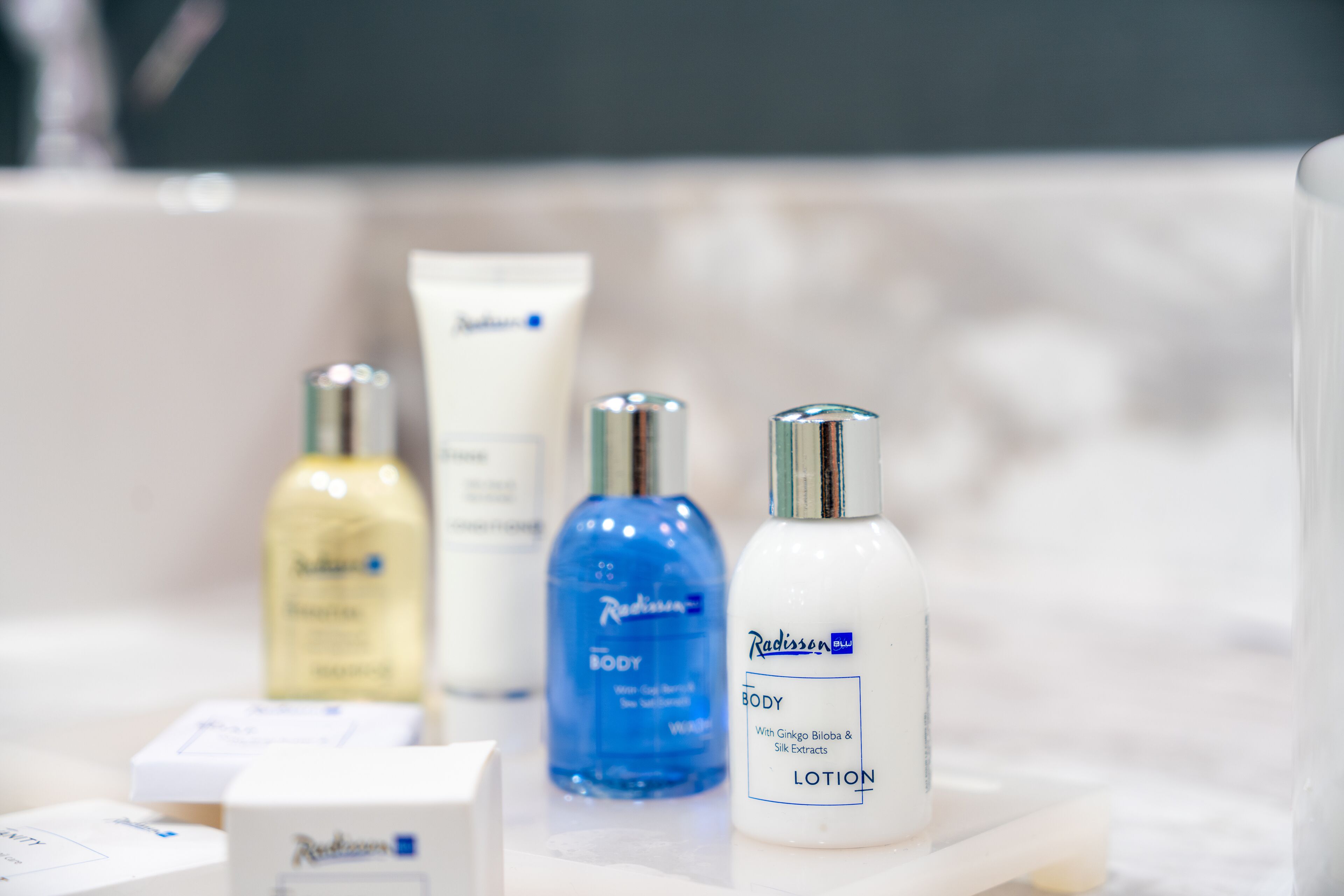 A bathroom shelf with various skincare products including lotions and body care items.