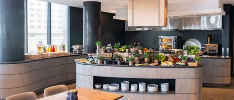 A modern kitchen with a central island, built-in appliances, and a dining area with a wooden table and chairs.