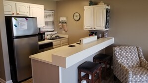 A compact kitchen with a refrigerator, microwave, sink, and a clock on the wall. - Lovely Lake Hamilton Condo, 1BR, Main Channel with an AMAZING VIEW! w/ boat slip (Hot Springs)