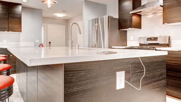 A modern kitchen with a large island, stainless steel appliances, and a sleek design. - Fully licensed pool home w/outdoor kitchen. (Las Vegas)