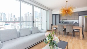 Een modern appartement met een groot balkon, een eethoek en een keuken.