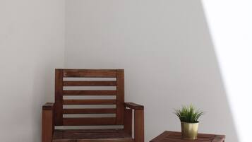 A wooden bench and a small table with a potted plant.