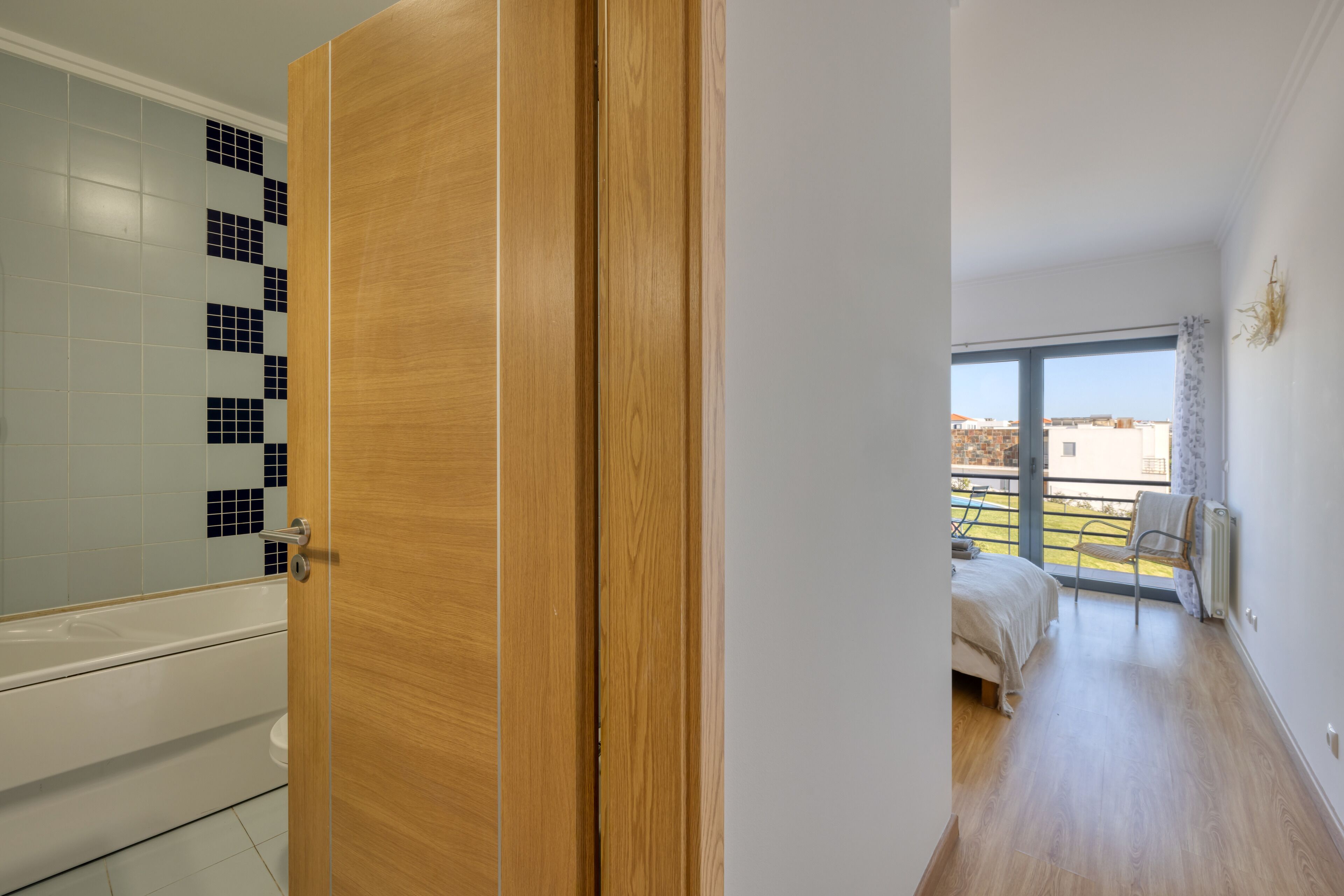 A modern bathroom with a bathtub and a shower area.
