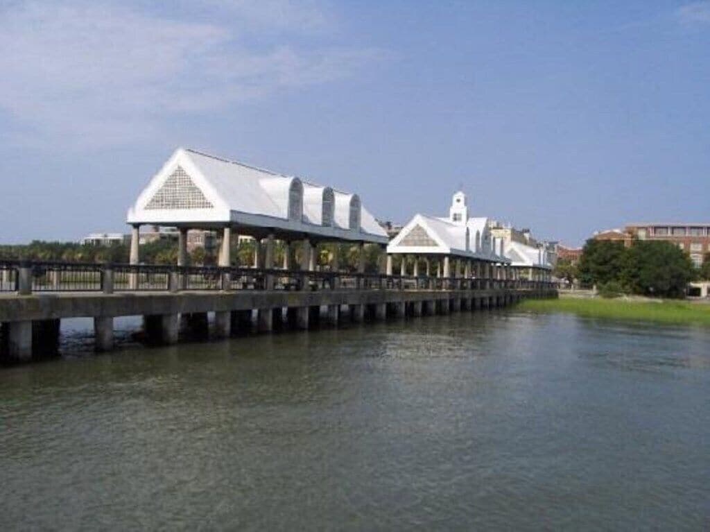 A bridge with white buildings on stilts over a body of water.