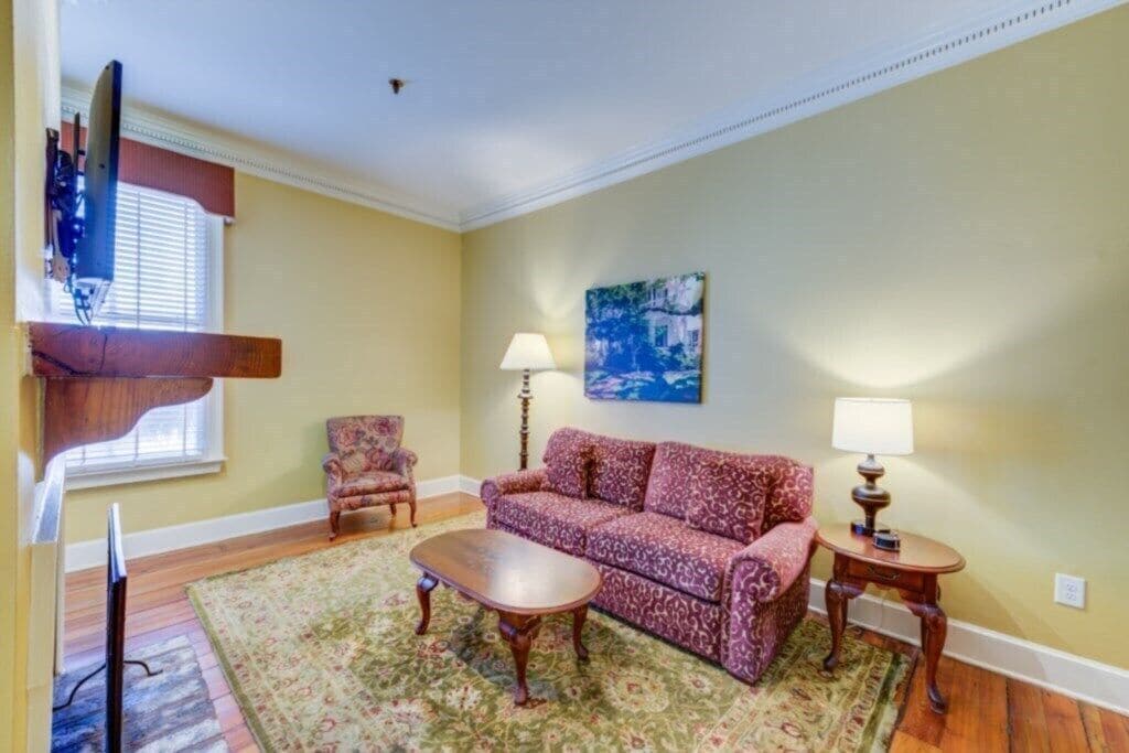 A living room with a sofa, two lamps, a chair, and a coffee table.