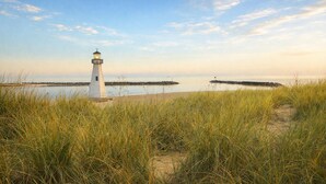A lighthouse with a clear view of the surrounding beach and water.