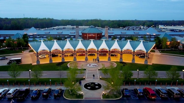 A hotel with a central courtyard, multiple parking levels, and a distinctive roof structure.