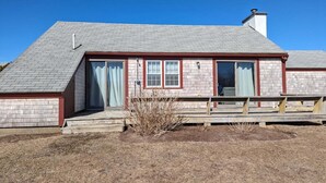 A single-story house with a gabled roof, a front porch, and a chimney. - Private cottage in Madaket just a 10 min walk or short drive to the beach. (Nantucket)
