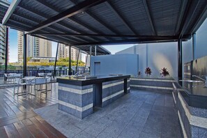 Relax in a stylish outdoor seating area with a long counter and comfortable chairs.