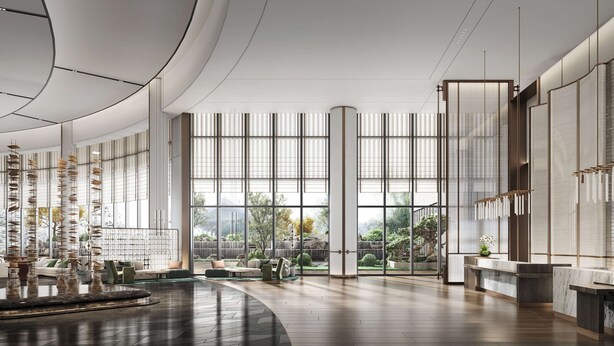 Un vestíbulo amplio con ventanas grandes, una mesa de recepción y una escultura decorativa de un pájaro.