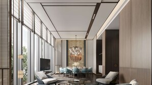 Una sala de estar moderna con un sofá, sillones, una mesa de centro y un televisor.