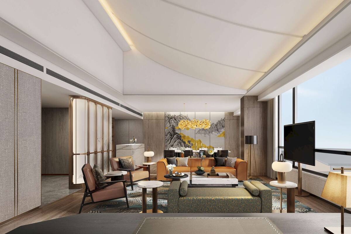 Une chambre d’hôtel moderne avec un grand lit, un canapé, une table basse et un téléviseur.