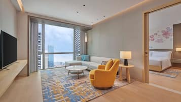 Junior Suite, 1 King Bed | Living area | 55-inch LED TV with cable channels, TV