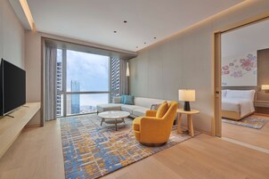 Junior Suite, 1 King Bed | Living area | 55-inch LED TV with cable channels, TV