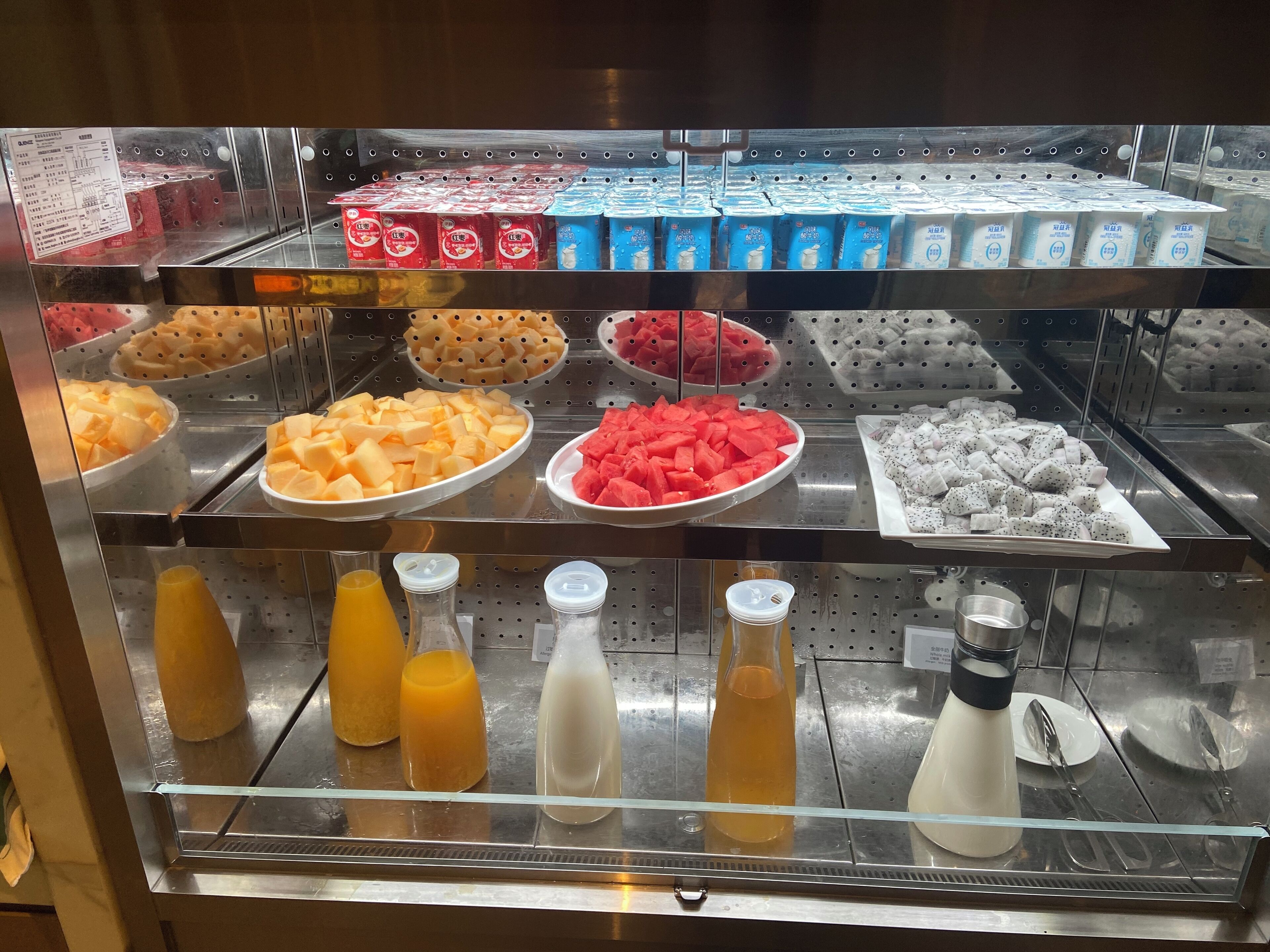 A refrigerated display case with various dairy products, including milk cartons and cheese.