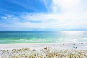 A beach with clear turquoise water and a sandy shore. - Beautifully renovated 3BR townhome with boat slip just steps from the beach! (Pensacola Beach)